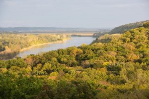 Fall color creeps into the woodlands above the Missouri River as seen from the scenic overlook at Indian Cave State Park in Nemaha and Richardson counties.
