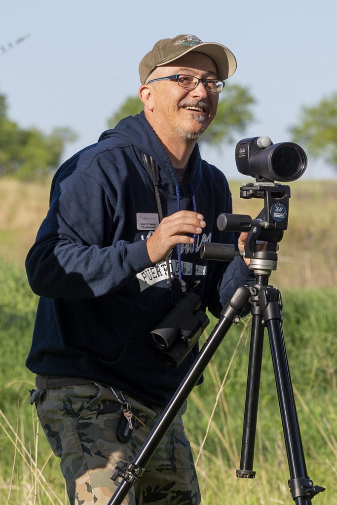 Pictured is Jason St. Sauver birdwatching at Spring Creek Prairie Audubon Center. 