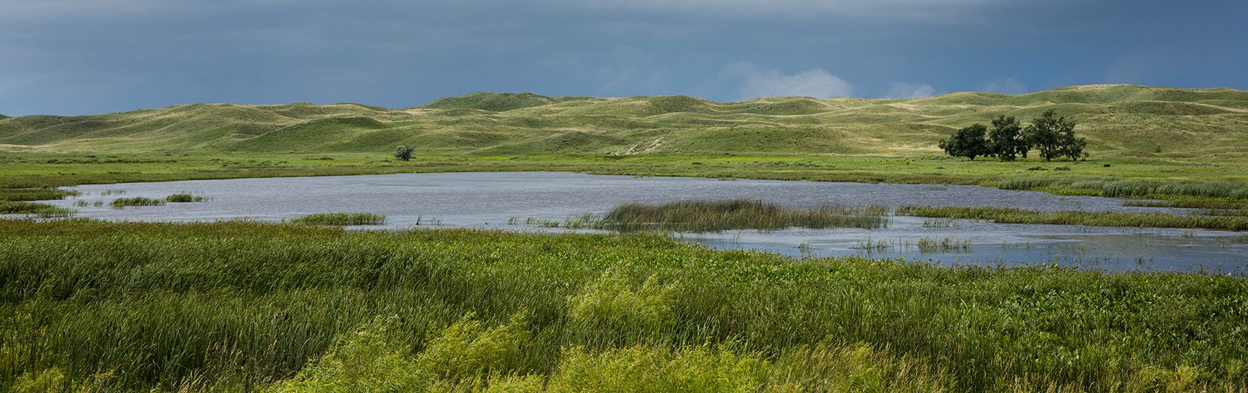 Storm clouds loom over a wetland in the Sandhills on the Valentine National Wildlife Refuge in Cherry County.